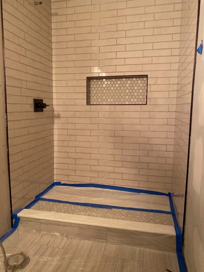 Our team installed the tile, built the niche, and installed the shower fixtures.